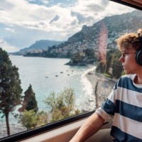 teenage boy travelling by train in french riviera - travel stock-fotos und bilder