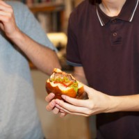 teenage boys eating hamburgers - junk food stock pictures, royalty-free photos & images