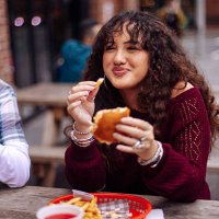 teenage girl eating fast food at street restaurant - junk food stock pictures, royalty-free photos & images