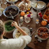 teenage girl having food while sitting at dining table during thanksgiving - home decoration stock pictures, royalty-free photos & images