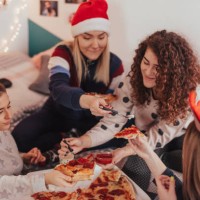 teenage girls eating pizza at sleepover christmas party - junk food stock pictures, royalty-free photos & images