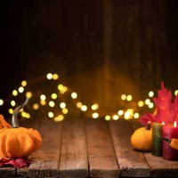 thanksgiving decoration with pumpkins and greeting card on illuminated background and a rustic wooden table - home decoration stock pictures, royalty-free photos & images