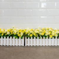 the artificial flower row in the white fence - garden decoration stock pictures, royalty-free photos & images