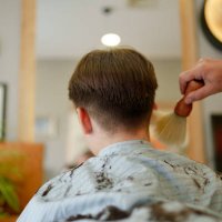 the barber is sweeping the hair - hairstyle stock pictures, royalty-free photos & images