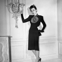 The Chinese influence that is sweeping New York's fall fashion showings predominates in this slim-body-molding dinner dress modeled in Nettie...