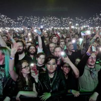 The crowd light up their phones as they watch Swedish heavy metal band Sabaton perform on stage during 'The Tour To End All Tours' at Wembley Arena...