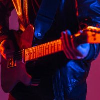 the guitar is close -up in the light of neon. unrecognizable man guitarist plays music on a musical instrument - concert stock pictures, royalty-free photos & images