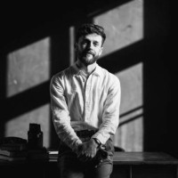 the male photographer with a film camera in the photo studio - fashion stock pictures, royalty-free photos & images