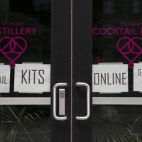 The Stilheart Distillery displays signs offering take-out cocktail kits in the North Loop neighborhood of Minneapolis, Minnesota, U.S., on Saturday,...