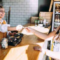 the woman pays for the food with a card - junk food stock pictures, royalty-free photos & images