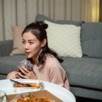 the young lady at home eating take-away - junk food stock pictures, royalty-free photos & images