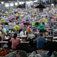 This photo taken on June 11, 2024 shows workers producing garments at a textile factory that supplies clothes to fast fashion e-commerce company...