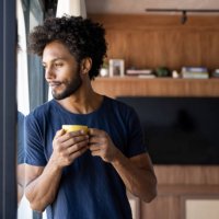 thoughtful man drinking a cup of coffee at home - coffee stock pictures, royalty-free photos & images