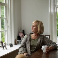 thoughtful senior woman having coffee - hairstyle stockfoto's en -beelden