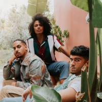 three beautiful young, fashionable people with a cool attitude pose in an outdoor area - fashion stock pictures, royalty-free photos & images