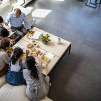 three generation family having lunch together - junk food stock pictures, royalty-free photos & images