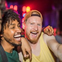 three happy young men partying at music festival at night. - concert stock pictures, royalty-free photos & images