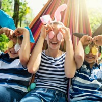 three kids playing with easter eggs found in the back yard - garden decoration stock pictures, royalty-free photos & images