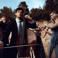 three musicians in blue dress and one musician in black suit in ancient theater. - concert stock pictures, royalty-free photos & images
