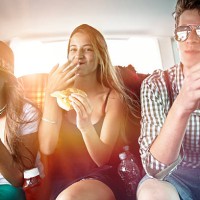 three teenage friends having a snack in car - food stock pictures, royalty-free photos & images