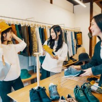 three women shopping together in a clothing store - fashion stock pictures, royalty-free photos & images