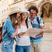 three young friends reading a map on the street in dubrovnik - travel stock pictures, royalty-free photos & images