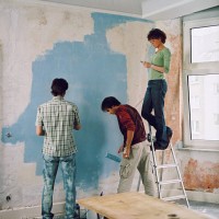three young people renovating a room - home decoration stock pictures, royalty-free photos & images