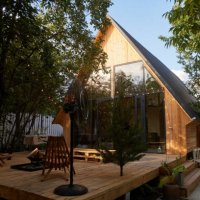 timber frame house with garlands building exterior view through trees - garden decoration stock pictures, royalty-free photos & images