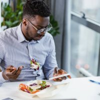 time for lunch and surfing the web on a mobile phone - junk food stock pictures, royalty-free photos & images