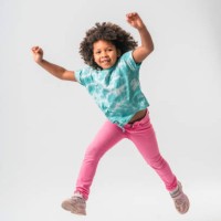 tiny caribbean girl jumping with joy - fashion stock pictures, royalty-free photos & images