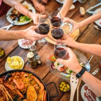 toasting with red wine and water before start of midday meal - food stock pictures, royalty-free photos & images