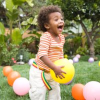 toddler boy (21-24 months) playing with balloons in yard - garden decoration stock pictures, royalty-free photos & images