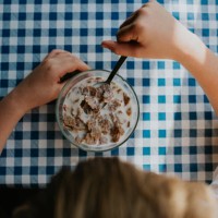 top down image of a child eating cereal - junk food stock pictures, royalty-free photos & images