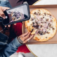 top down view of an italian pizza in new york being posted on social media - junk food stock pictures, royalty-free photos & images