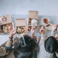 top view asian chinese young family enjoying take out food in front of tv in living room during weekend - junk food stock pictures, royalty-free photos & images