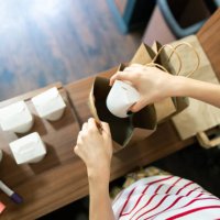 top view of fast food worker packing food for delivery - junk food stock pictures, royalty-free photos & images