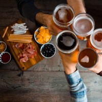 top view of friends toasting with beer glasses in the pub - food stock pictures, royalty-free photos & images