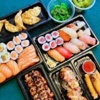 top view of quality sushi and sashimi set takeaway with japanese side dishes on table laid with tablecloth - junk food stock pictures, royalty-free photos & images