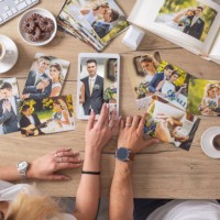 top view of wedding pictures collection on a table, viewed by a couple having coffee and biscuits. - home decoration stock pictures, royalty-free photos & images