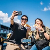 tourist couple taking selfie with smart phone while experiencing and eating street food during their travel - travel stock pictures, royalty-free photos & images