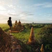 tourist standing on bagan pagoda during sunrise in myanmar - travel stock pictures, royalty-free photos & images