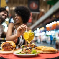 tourists eating and drinking at municipal market - food stock pictures, royalty-free photos & images