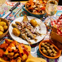 traditional portuguese dinner with grilled sardines, potatoes, olives, octopus salad and fresh bread, lisbon, portugal - food stock pictures, royalty-free photos & images
