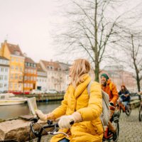 travel guide and her group on the bicycles through the town - travel stock pictures, royalty-free photos & images
