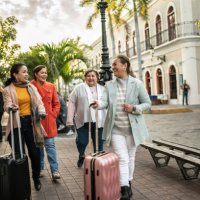 traveler senior friends walking with suitcases outdoors - travel stock pictures, royalty-free photos & images