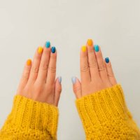 trendy bright manicure on woman hands in illuminating yellow knitted sweater against ultimate gray background. trendy colors of the year 2021. flat lay style. close-up - nails art stock pictures, royalty-free photos & images