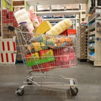 trolley filled with groceries in wholesale store landscape - junk food stock pictures, royalty-free photos & images