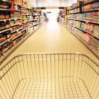 trolley in supermarket aisle - food stock pictures, royalty-free photos & images