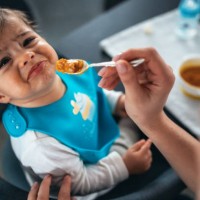 trying to feed a baby boy - food stock pictures, royalty-free photos & images