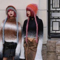 Twins Ami & Aya Amiaya were seen wearing a black and brown skirt, colorful hats and white and brown as well as white and black striped pullover with...